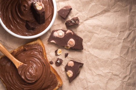 Sweet chocolate spread on bread with cream and bars. Top view.の写真素材