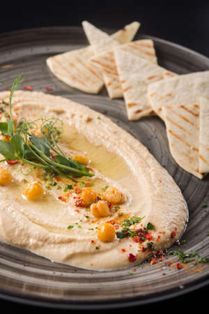 Vegetarian food hummus with chickpea in a restaurant table.の写真素材