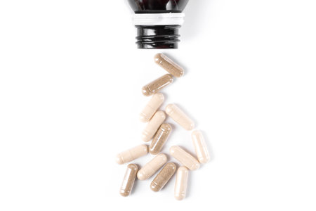 Medical bottle with pills isolated on a white background. top view