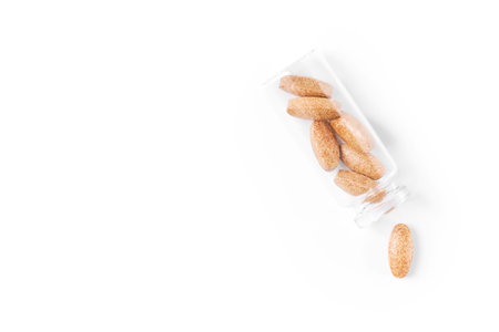 Medical pills in a glass container isolated on a white background