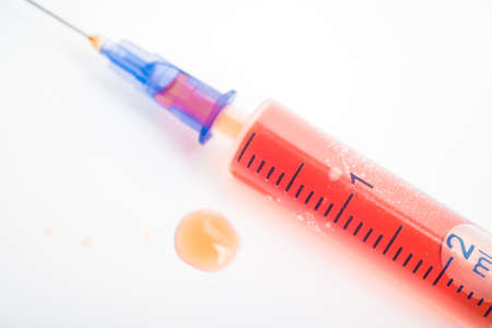 Syringe with injection isolated on a white background. vaccination, blood sampling.の写真素材