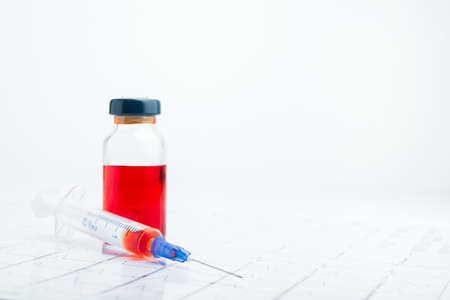 ECG results on paper and red injections to restore heart pulse. Heart attack or hypertensionの写真素材