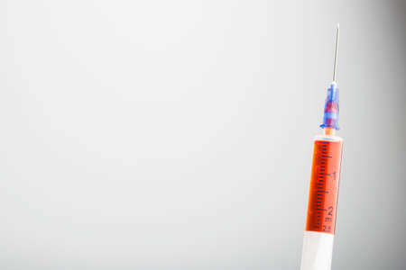 Syringe with injection isolated on a white background. vaccination, blood sampling.の写真素材
