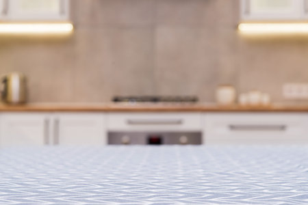 Focus on a vintage tablecloth table and scandinavian kitchen defocused on background.の写真素材
