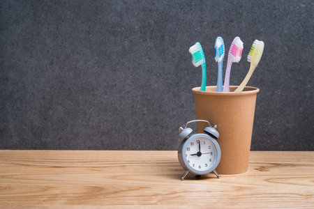 Toothbrush in holder with clock. Concept of cleaning and care of the teeth in a scandinavian...