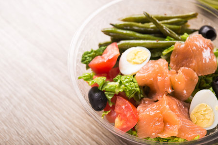 Plastic lunchbox with salmon, egg, tomato, asparagus salad. Healthy lunch food.の写真素材