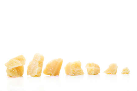 Parmesan cheese pieces isolated on white backgroundの写真素材