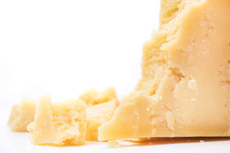 Parmesan cheese pieces isolated on white backgroundの写真素材