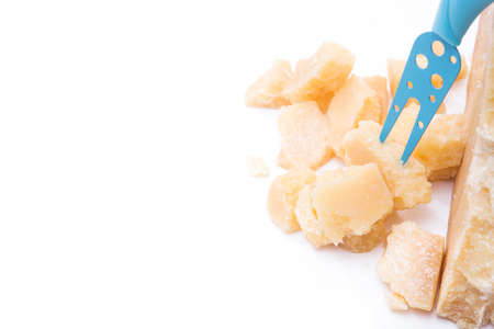 Pieces of parmesan cheese and knife isolated on white backgroundの写真素材