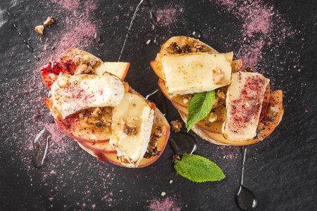 Tasty italian bruschetta with cheese brie, camembert and peach at a cafe table. Top view.の写真素材