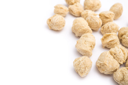 Soya protein chunks isolated on a white background. Vegan and diet food.