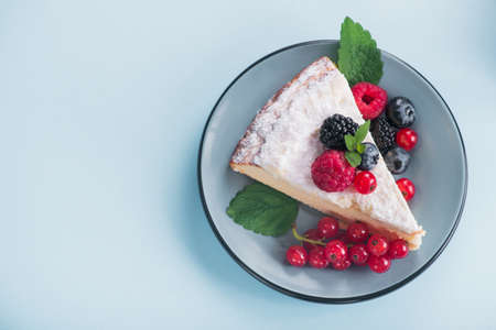 Sweet dessert cake with fresh blackberry, raspberry, currants and blueberry and green mint. top viewの写真素材