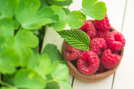 Fresh and natural raspberry with mint on a wooden table. Berry organic, vitamin food.