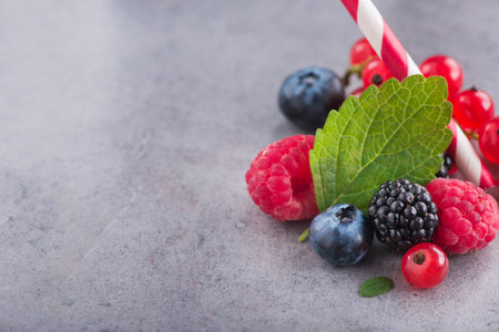 Closeup of fresh berry, currants, blueberry, raspberry on a stone background. vitamin mixed. copy...