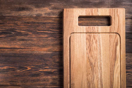 Empty wooden cutting board on a table. top view. copy space for textの写真素材
