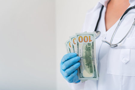 Doctor in clinic with a bundle of dollar bills. Corruption and bribery in medicine. Paid treatment....