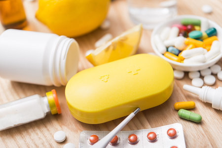 Yellow capsule container box with pills for daily take medicine. treatment of influenza flu virus.の写真素材