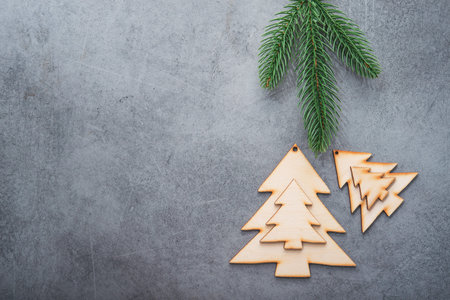 Decor wooden fir tree with branches on a stone background. Concept of Merry Christmas holiday. Top view. Flat Lay. Copyspace.の写真素材