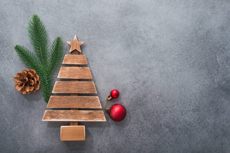 Decor wooden fir tree with branches on a stone background. Concept of Merry Christmas holiday. Top...