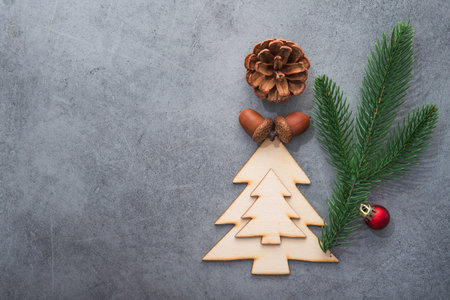 Decor wooden fir tree with branches on a stone background. Concept of Merry Christmas holiday. Top view. Flat Lay. Copyspace.の写真素材