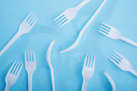 Creative concept of reducing the use of plastic tableware on a pastel color background. flat lay. top viewの写真素材