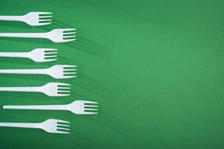 Creative concept of reducing the use of plastic tableware on a pastel color background. flat lay. top viewの写真素材