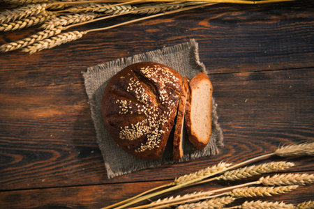 Tasty rye bread with sesame on a wooden background. Top view.