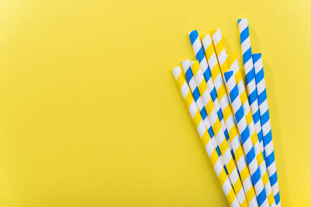 Bright yellow colored cocktail straw on a color background. recycling eco concept. minimal style. flat lay. topの写真素材