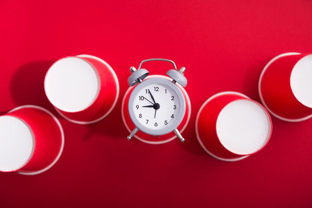 Bright red background with paper cup of coffee. Ecology time concept. Minimal background. Top view. Flat Lay. Transition from plastic to paper.の写真素材