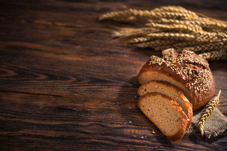 Tasty rye bread with sesame on a wooden background. Top view.の写真素材
