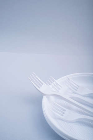 Creative concept of reducing the use of plastic tableware on a pastel color background.の写真素材