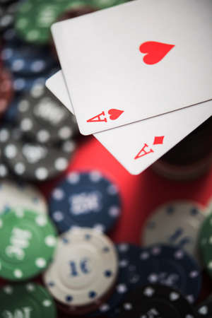 A pair of two aces with poker chips. closeup of casino table. texas holdem.の写真素材