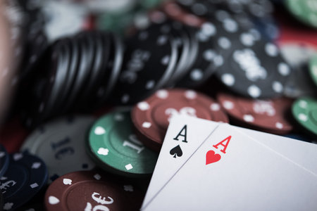 A pair of two aces with poker chips. closeup of casino table. texas holdem.