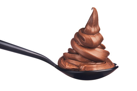 Melted chocolate pile on a spoon isolated on a whiteの写真素材