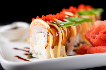 Closeup of sushi rolls on a black background. Japan food.
