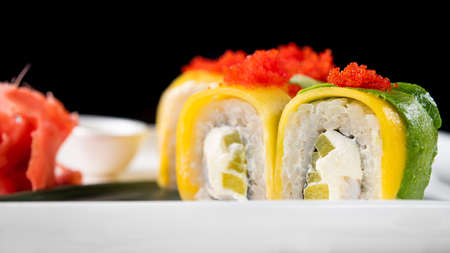 Closeup of sushi rolls on a black background. Japan food.の写真素材