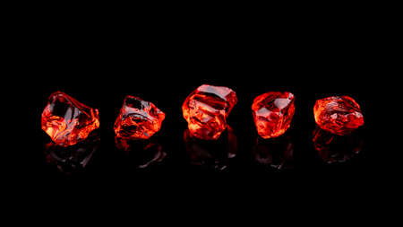 Closeup of red gems stone garnet isolated on a black background. Banner size. Wide format.の写真素材