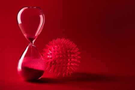 Red coronaviruses influenza with hourglass on background. danger of the ncov virus. Pandemic concept.の写真素材