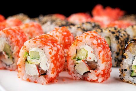 Closeup of sushi rolls on a black background. Japan food.の写真素材
