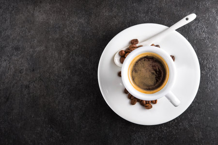 White coffee cup on a dark stone background. top view. copyspace