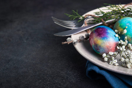 Vintage color easter eggs on a plate, dark stone background.の写真素材