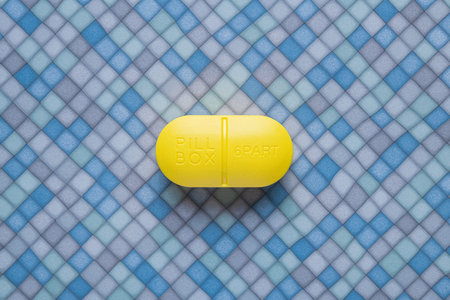 Yellow pill box on a in the bathroom floor background. top viewの写真素材
