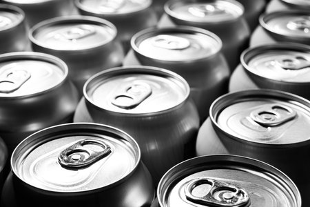 Many cans of beer on a background. 