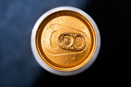 Frosty drink beer can with water drops on background. top view.