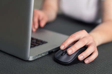 Left-handed girl working on a laptopの写真素材