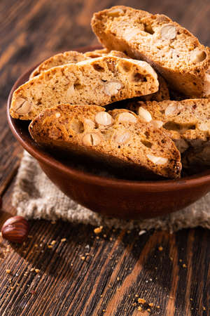 Tasty sweet cantuccini cookies with nuts and almonds on old wooden table. italian dessert snack background.の写真素材