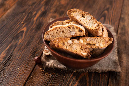 Tasty sweet cantuccini cookies with nuts and almonds on old wooden table. italian dessert snack background.の写真素材