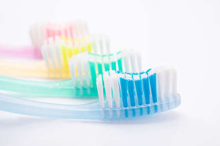 Set of toothbrushes for a family of four isolated on a white background. Oral hygiene concept.の写真素材