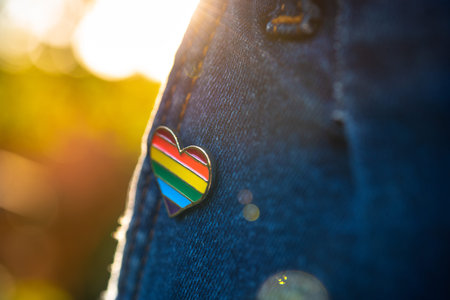 Rainbow color lgbt heart badge on jeans. Closeup photo. Freedom concept parade.
