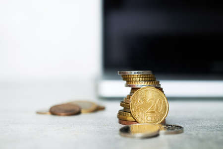 Euro coins with laptop on a background.の写真素材